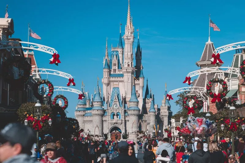 Crowds on Main Street USA with Cinderella Castle dressed for Christmas at Magic Kingdom Orlando