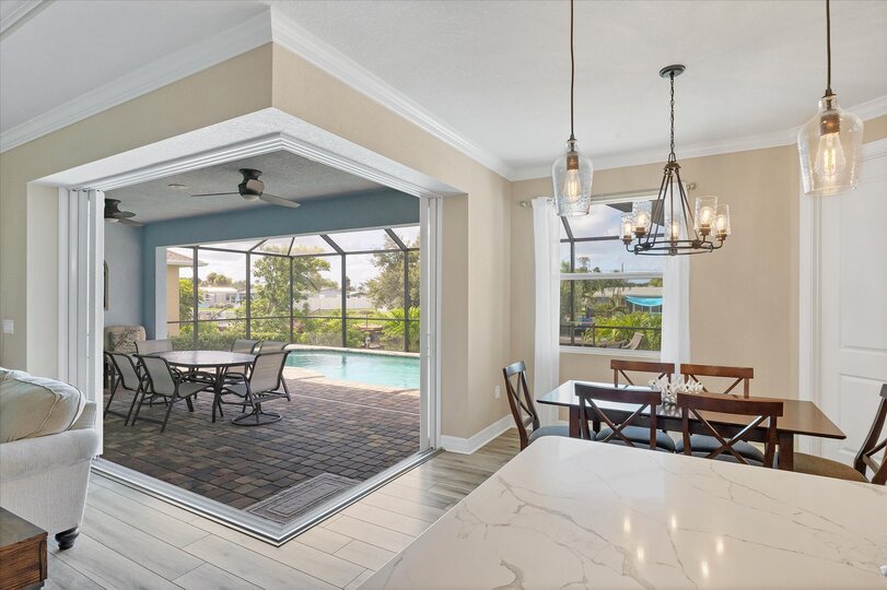 Kitchen and dining area overlooking the sparkling pool and canal