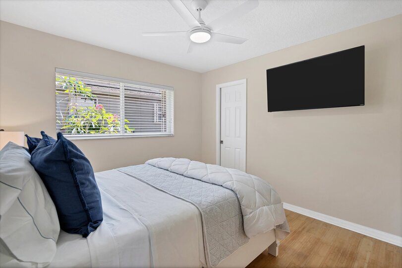 Guest bedroom with queen bed and 50-inch Smart TV