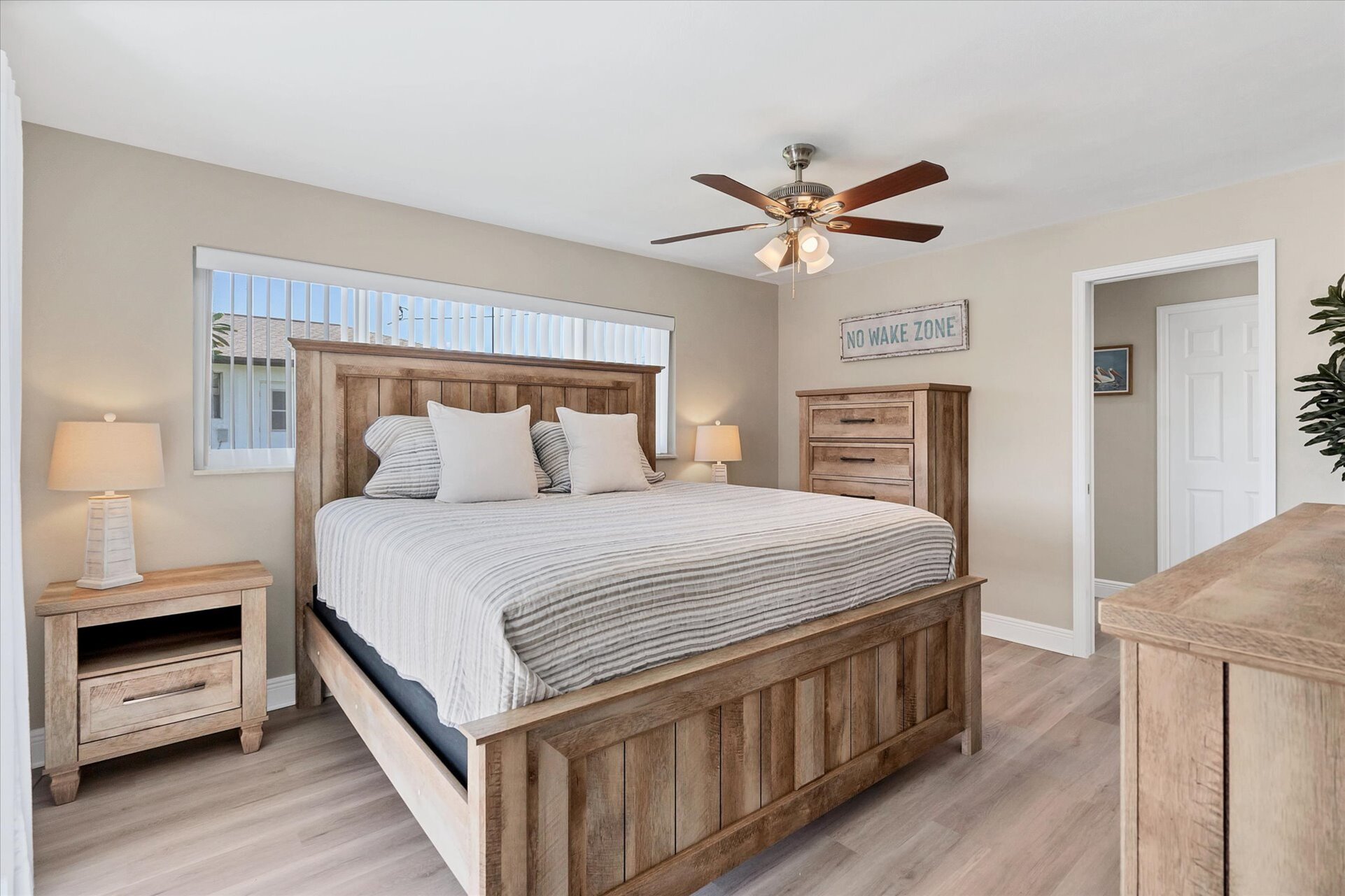 Primary bedroom with king bed, attached bathroom, and 50-inch Smart TV