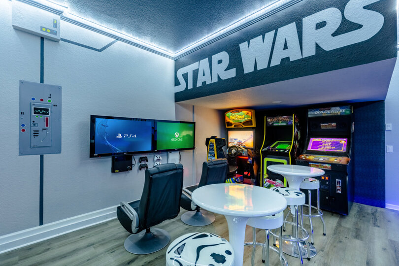 Two gaming chairs and TVs set up with Xbox One & PS4 gaming consoles.