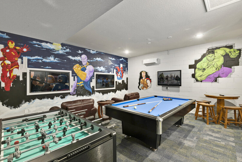 Featuring a foosball table, pool table, gaming system and table and chairs