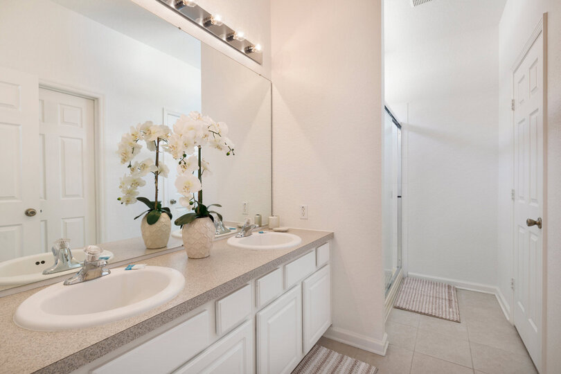 The ensuite bath has dual vanity and walk-in shower