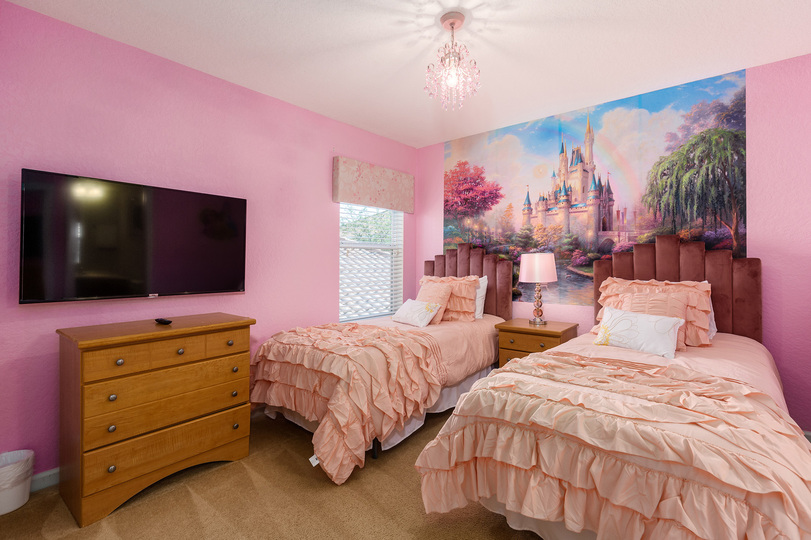 A kids bedroom featuring two twin beds with SMART TV