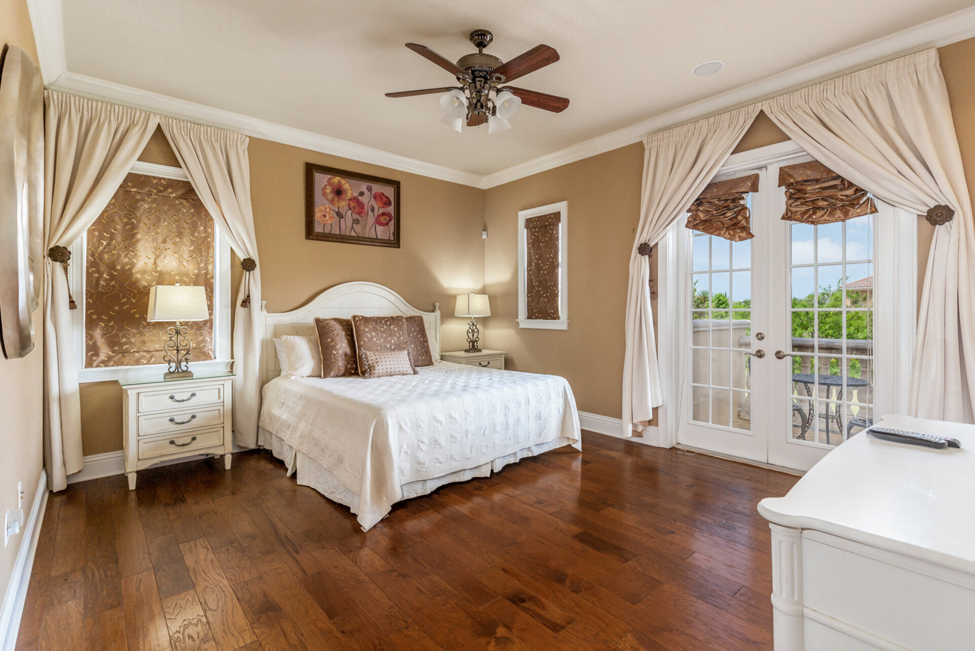 The lavish master suite features a comfortable king bed