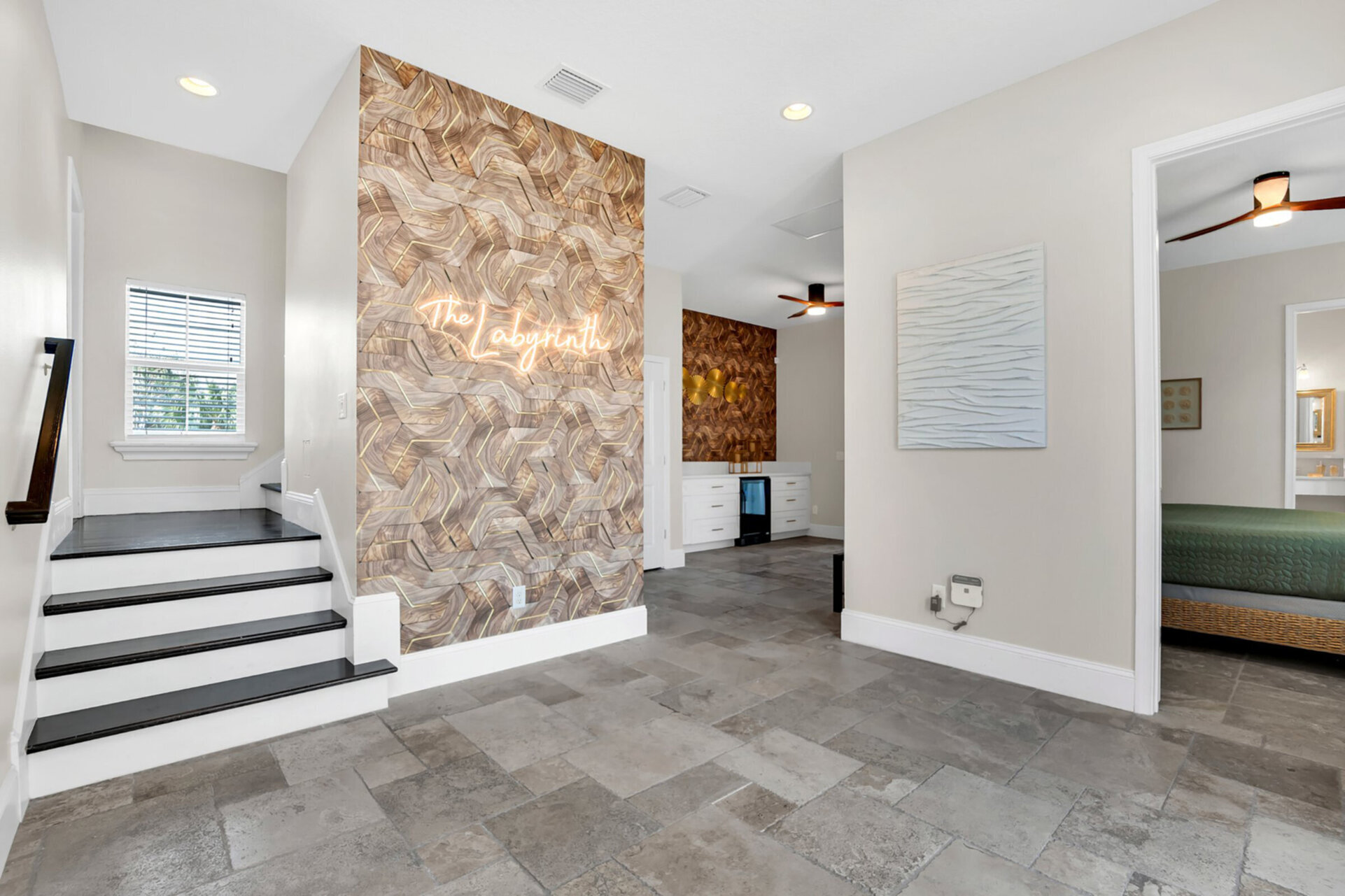 As you walk into the home you will be greeted by abstract art, 2 king-suites and a mini wet bar. Access to the pool is also on the ground floor.