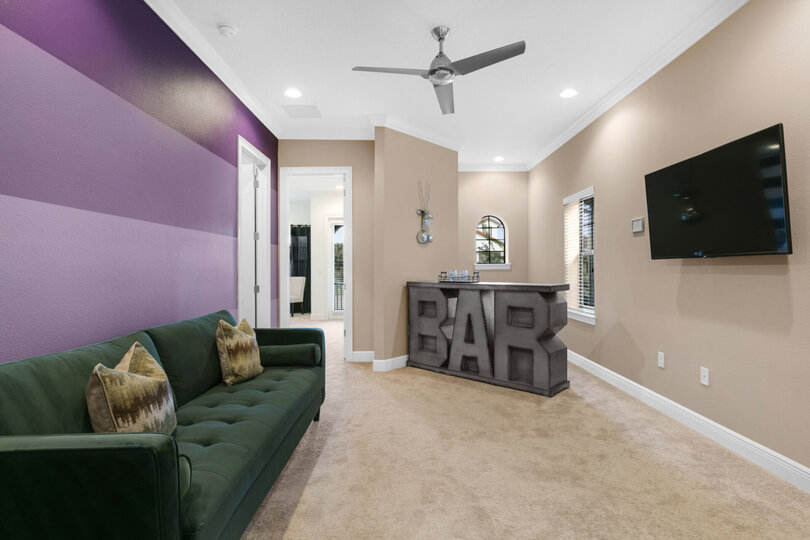 The second floor loft spaces offers an additional TV area with a wetbar