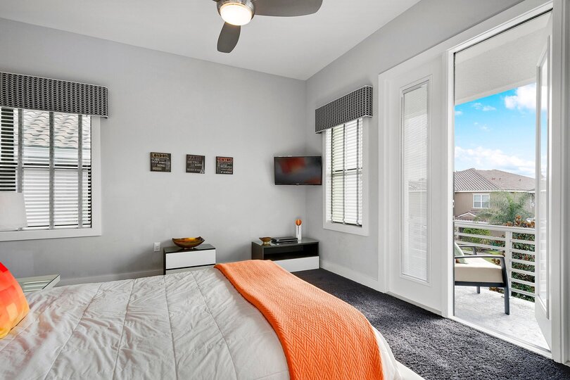 The bedroom also features a 32-inch TV and access to a private balcony