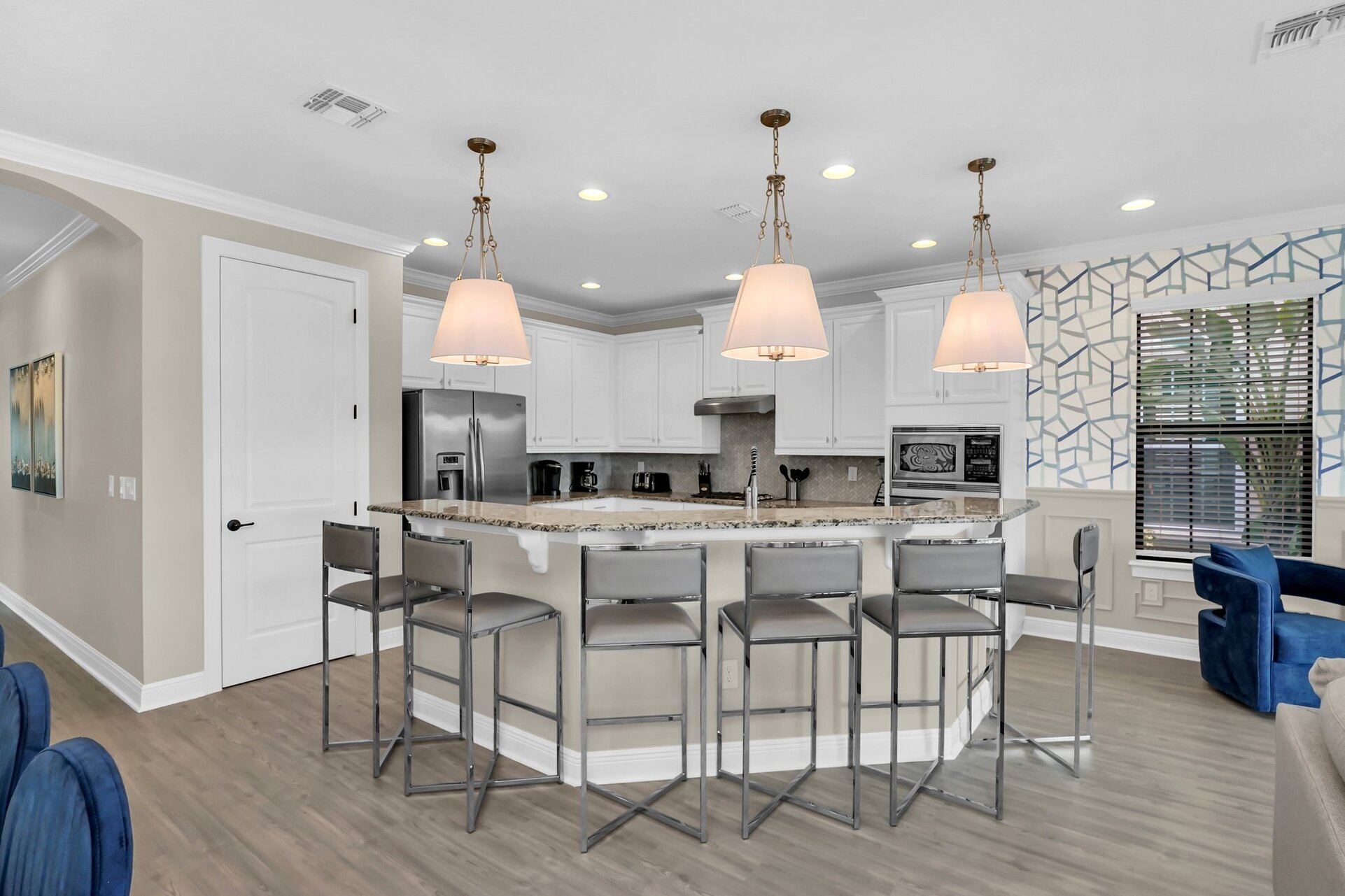 Fully equipped kitchen with stainless steel appliances and breakfast bar with seating for 6