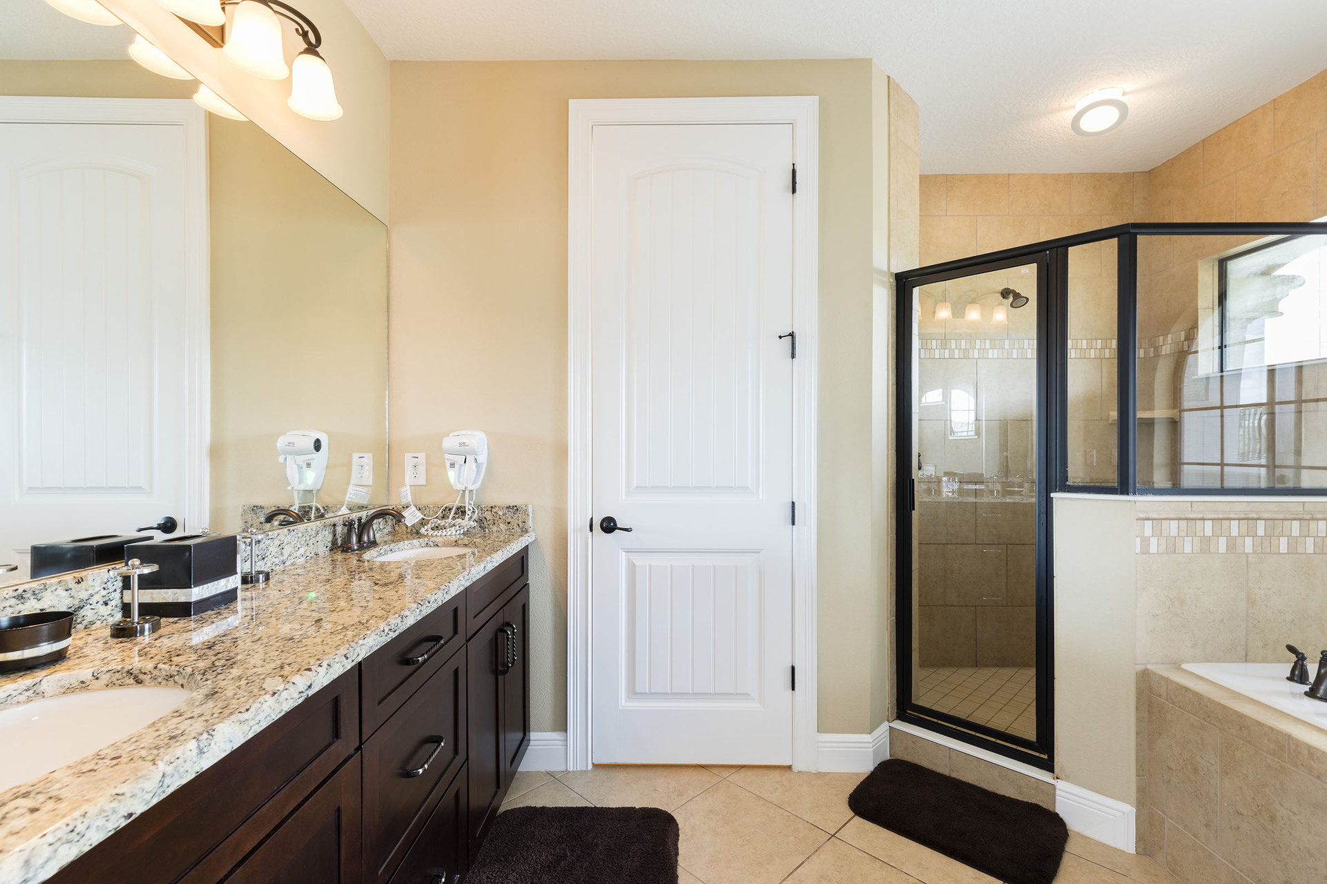 The en-suite bathroom has a dual vanity, walk-in shower, and garden tub