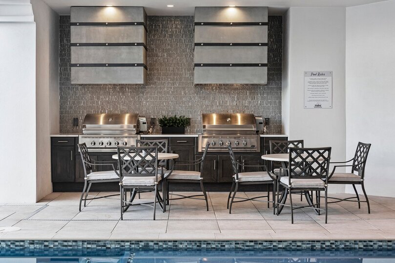 Enjoy the gorgeous outdoor living space, complete with a summer kitchen, wet bar and plenty of comfortable outdoor seating