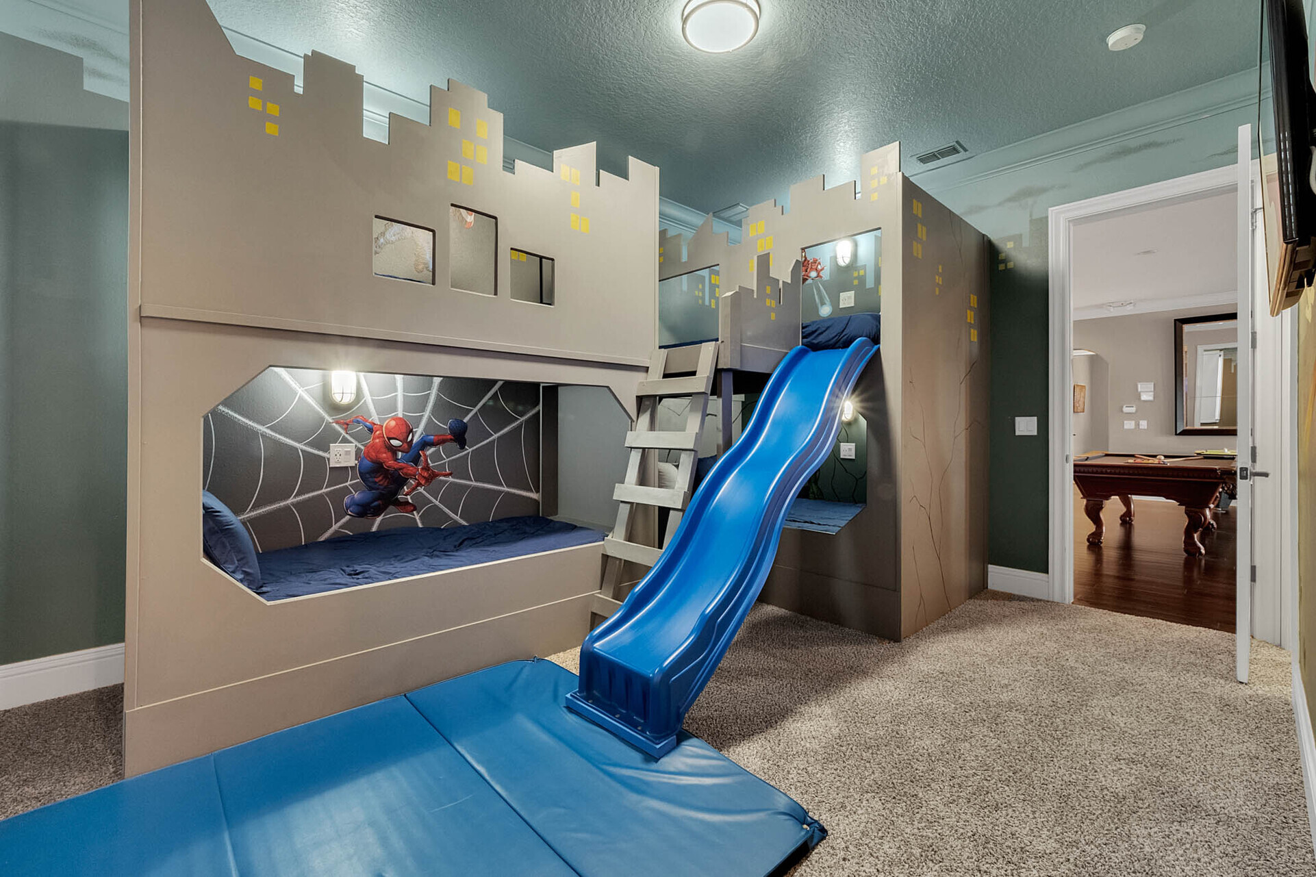 Superheroes can slide all day in their bedroom with two full beds and two twin beds
