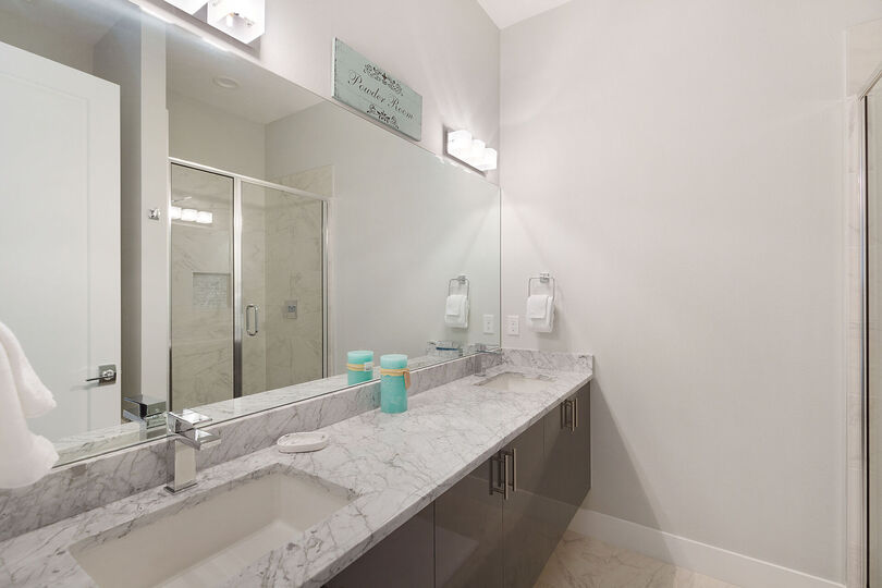 Sleek ensuite bathroom with a dual vanity and walk in shower