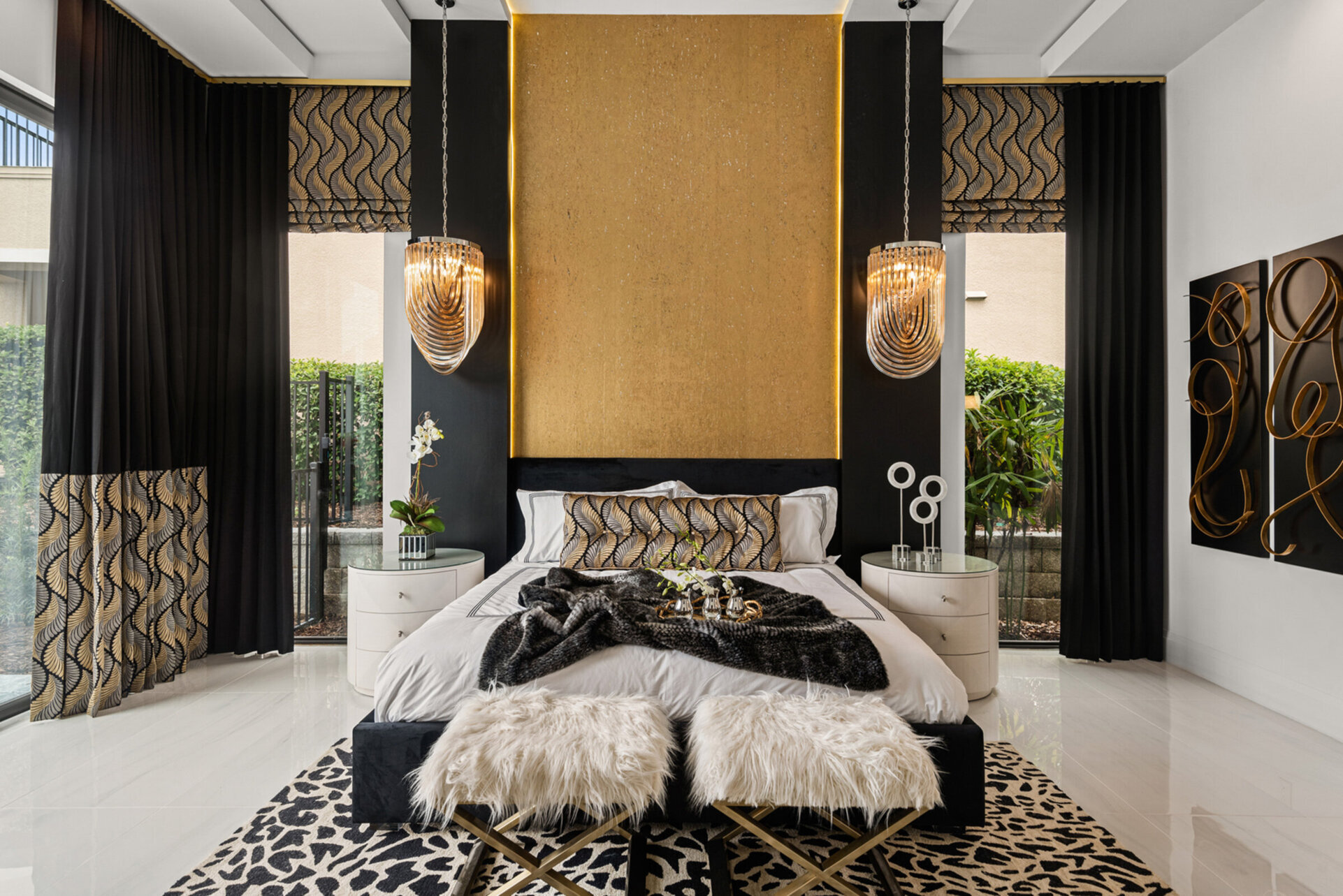 The ground floor Grand Master Suite is furnished with a king-size bed