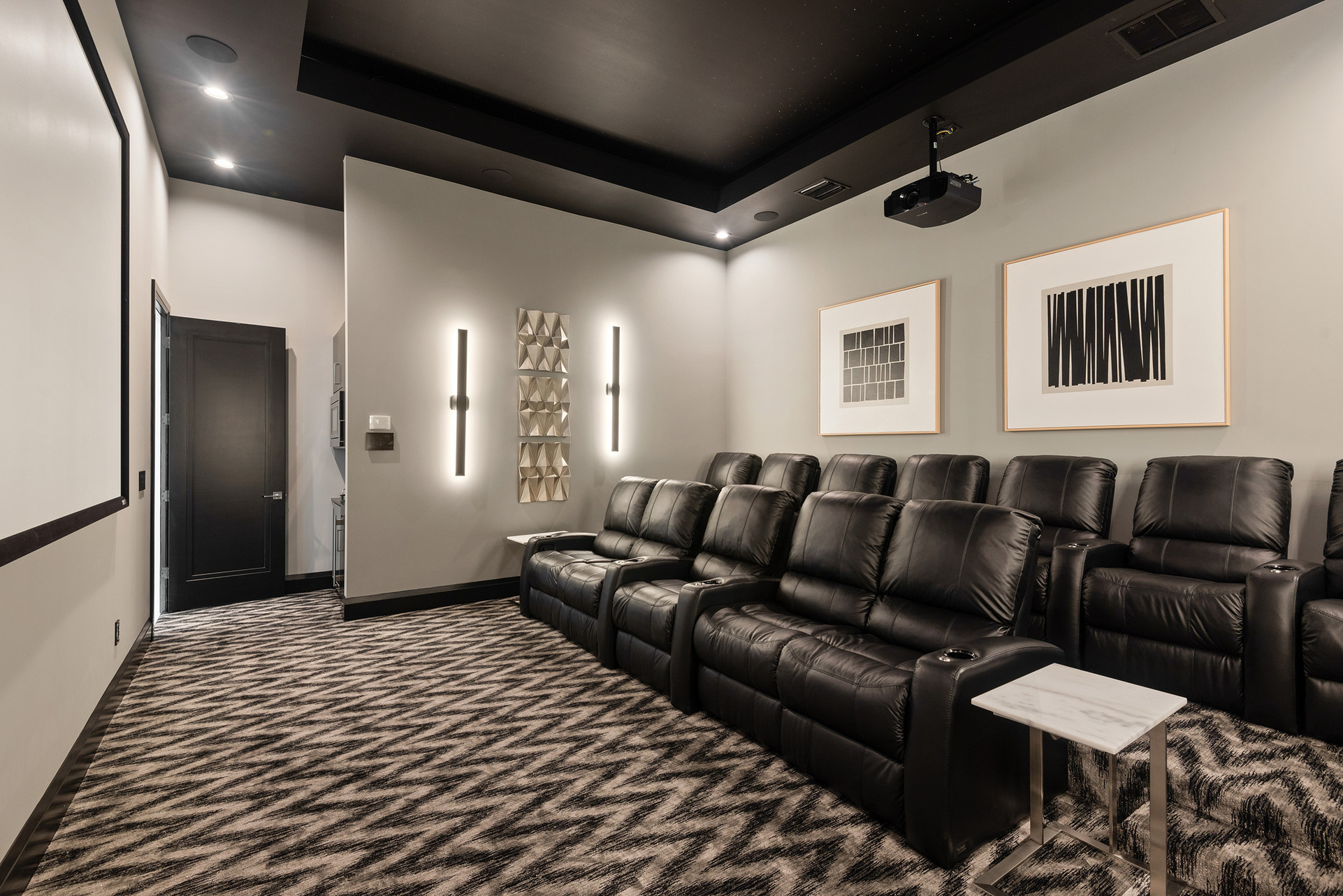 The theater room comes with 12 recliner seats to sit back, relax, and watch a movie