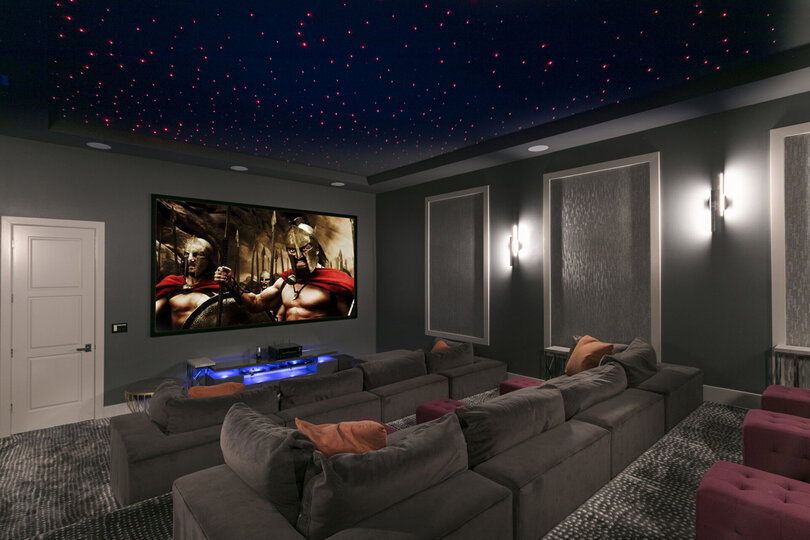 The theater room has couch seating for 13 people