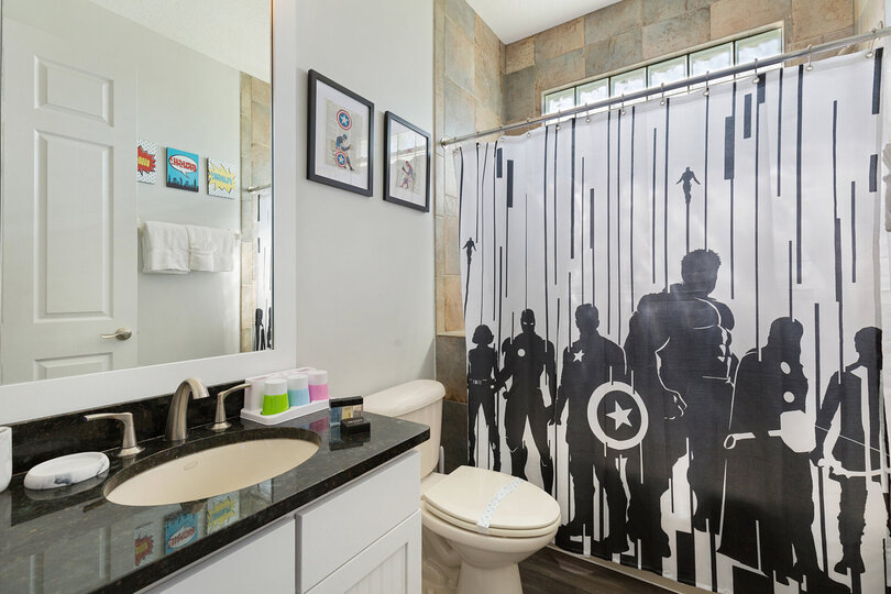 The ensuite bathroom features a shower/tub combination