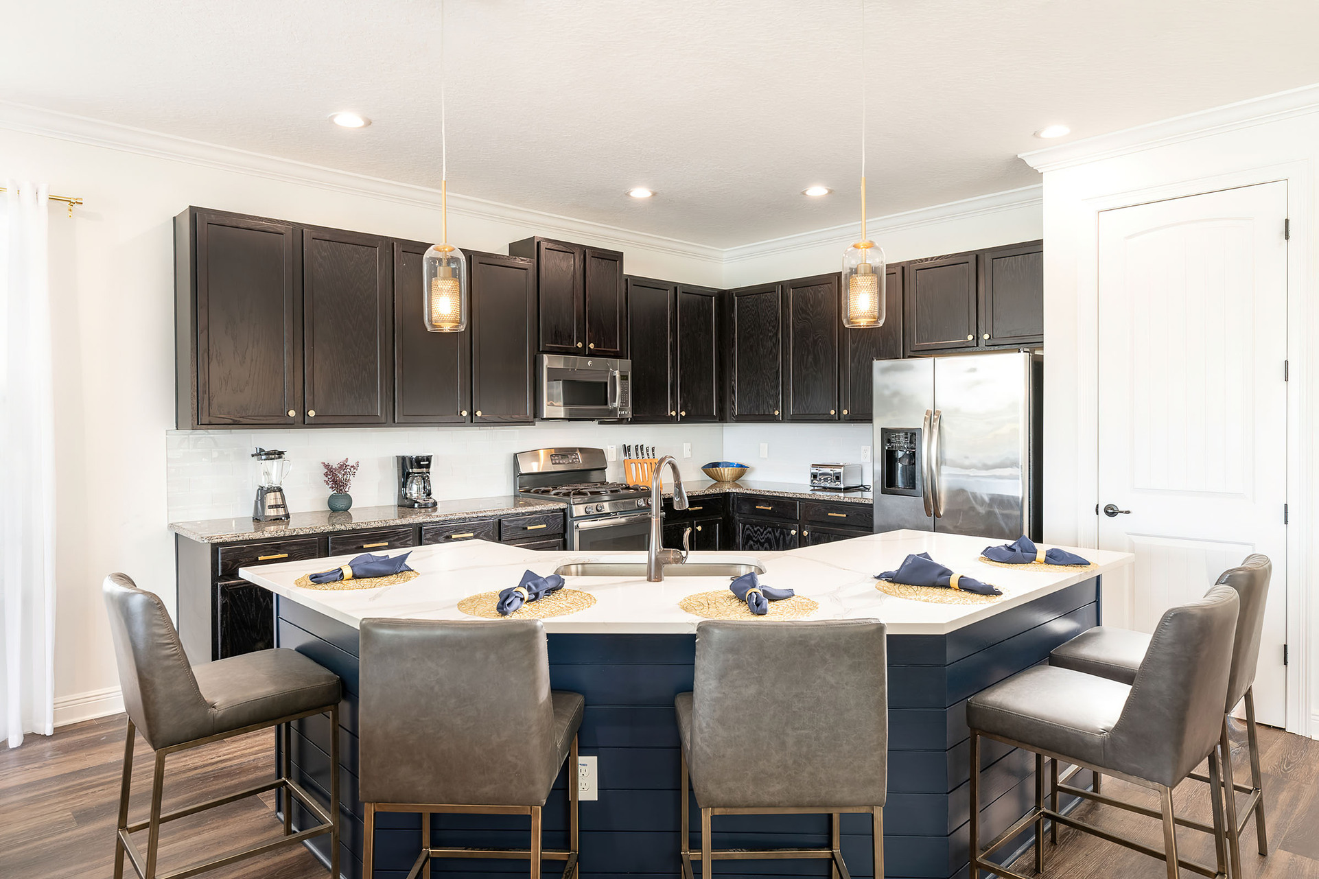 The fully equipped kitchen, complete with granite countertops and stainless-steel appliances, makes preparing meals a delight