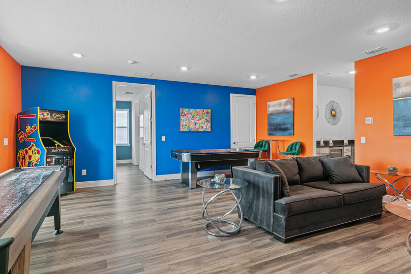 Upstairs, you'll find the entertainment loft with shuffleboard, air hockey, a multi-game arcade, a Smart TV with Xbox, and a wet bar with a wine fridge and a drink fridge