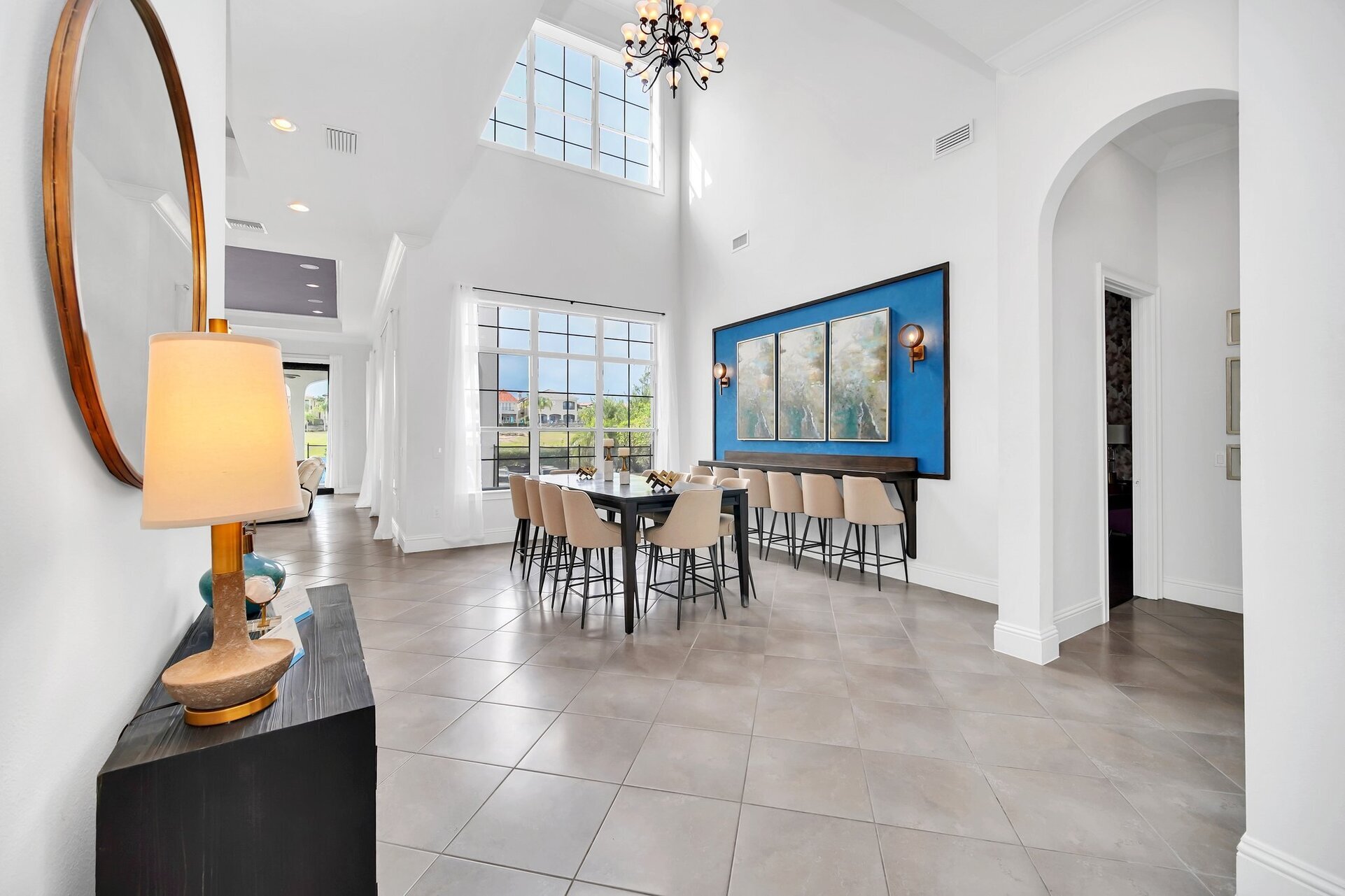 Savor every meal in style under the expansive, light-filled ambiance of our dining area, adorned with towering ceilings and breathtaking natural light pouring in through glass walls.