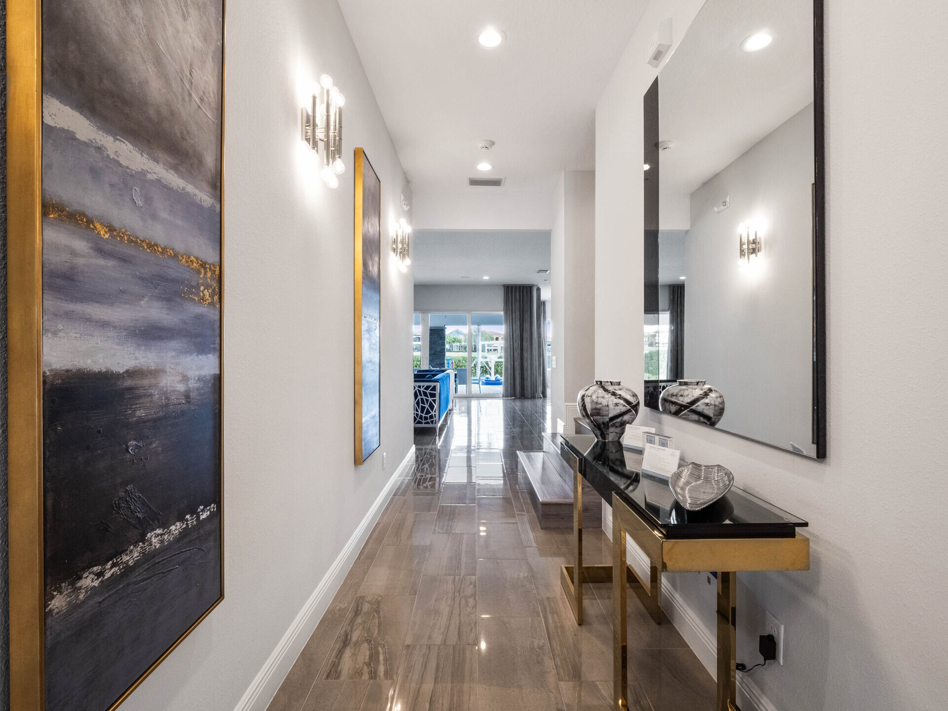 Adorned with exquisite paintings and a grand mirror, it's a corridor of elegance leading to the pool area.