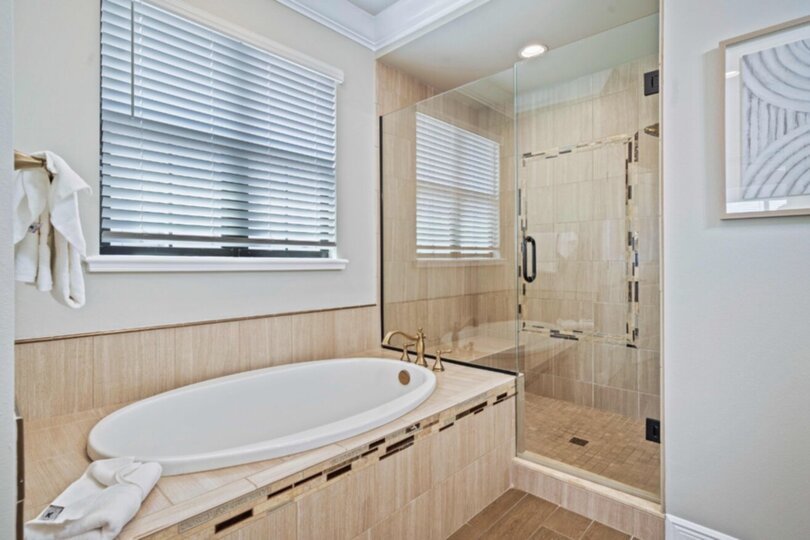 En-suite bathroom with large soaking tub and glass door walk-in shower