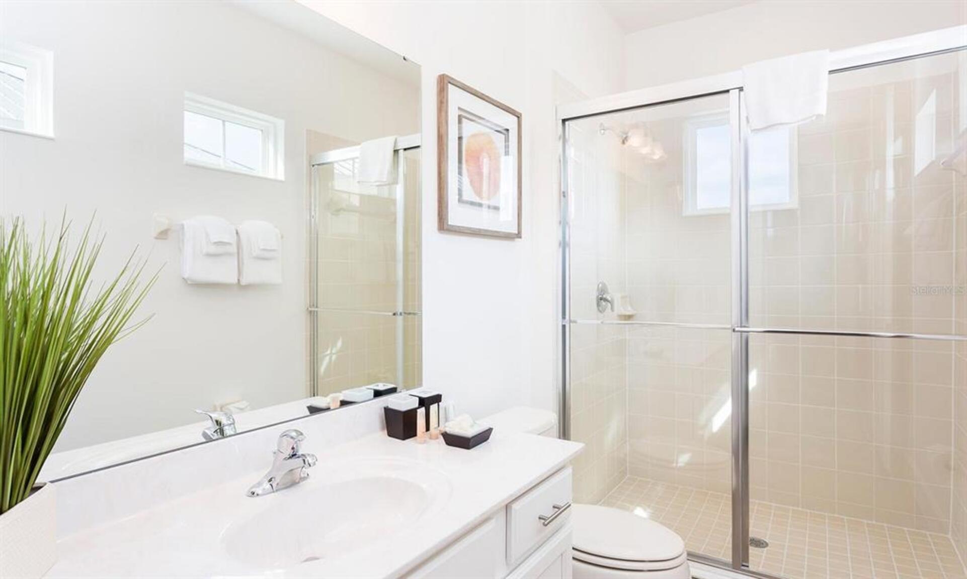 Enjoy the convenience of an en-suite bathroom featuring a walk-in shower for a refreshing start to your day