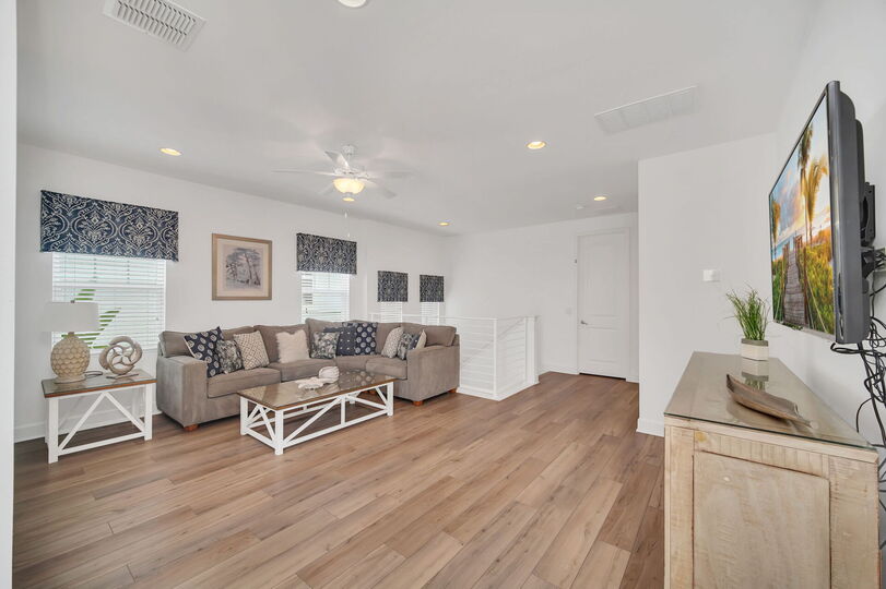 Gather in the 2nd floor loft area, a versatile space perfect for lounging, watching movies, or enjoying casual conversations.