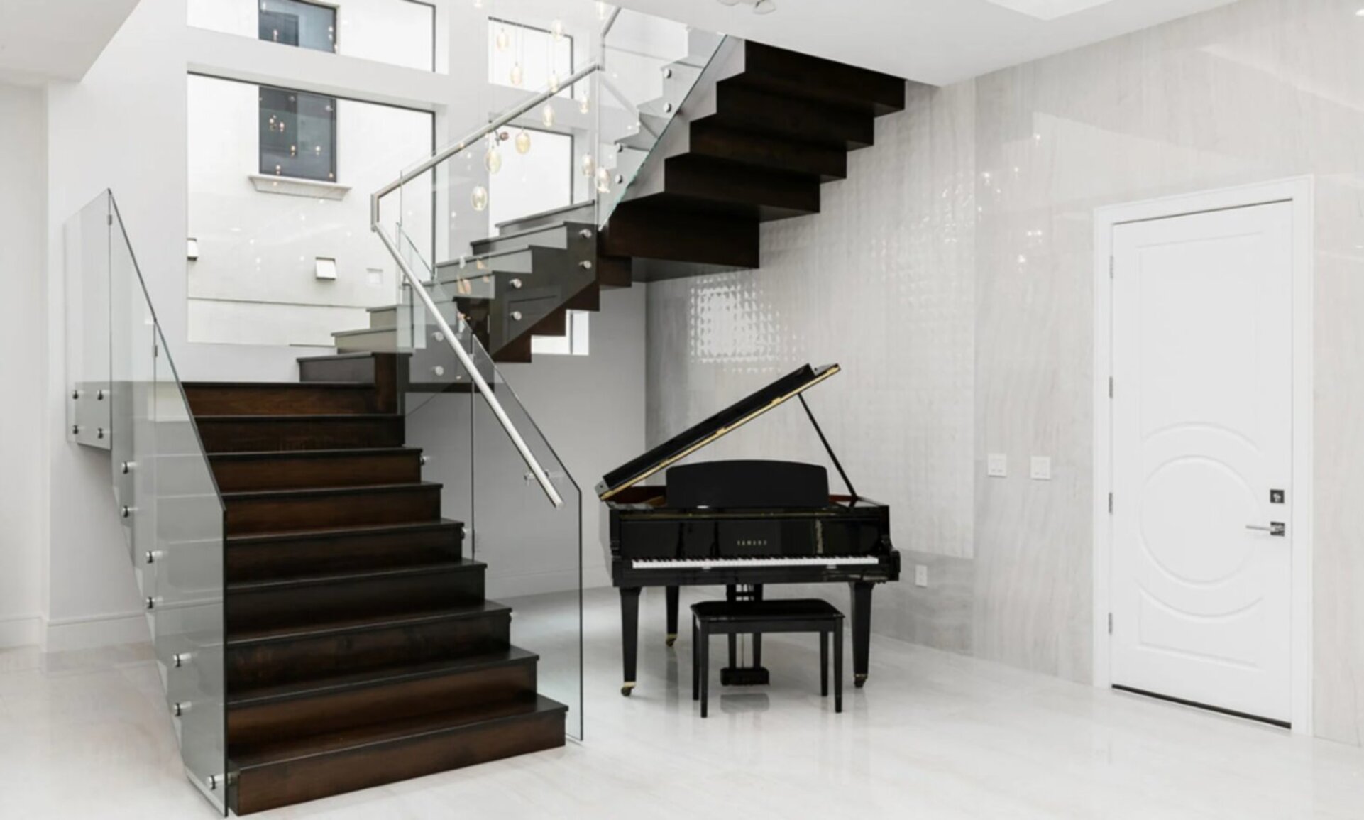 Yamaha Piano Beneath Modern Staircase