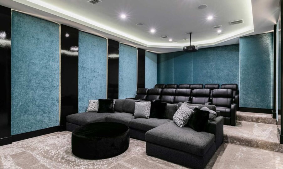Theatre with 12 Black Leather electric reclining seats and oversized deep lush fabric sectional