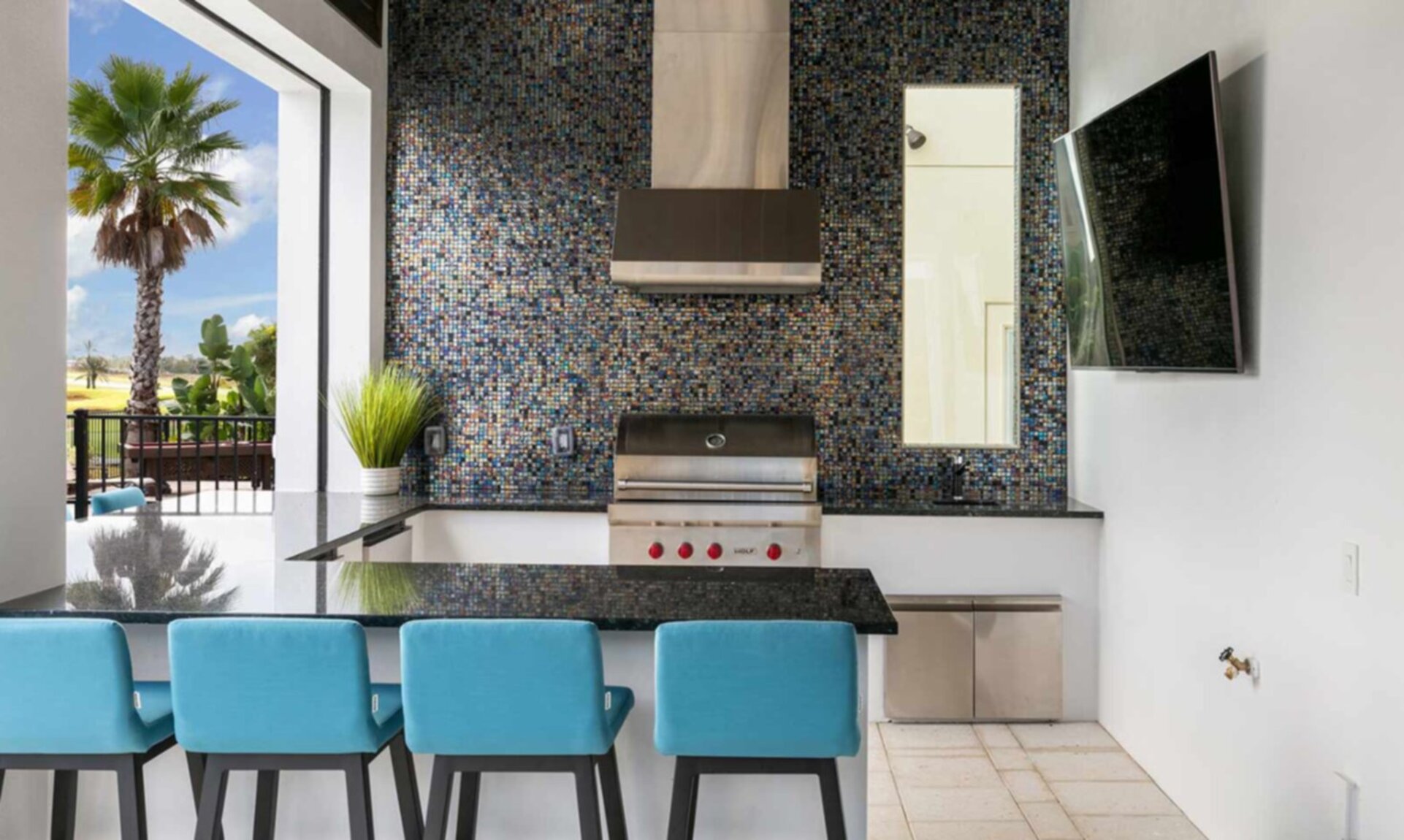 Outdoor Kitchen with Wolf Gas Grill, Refrigerator, Ice maker, and 75 inch TV