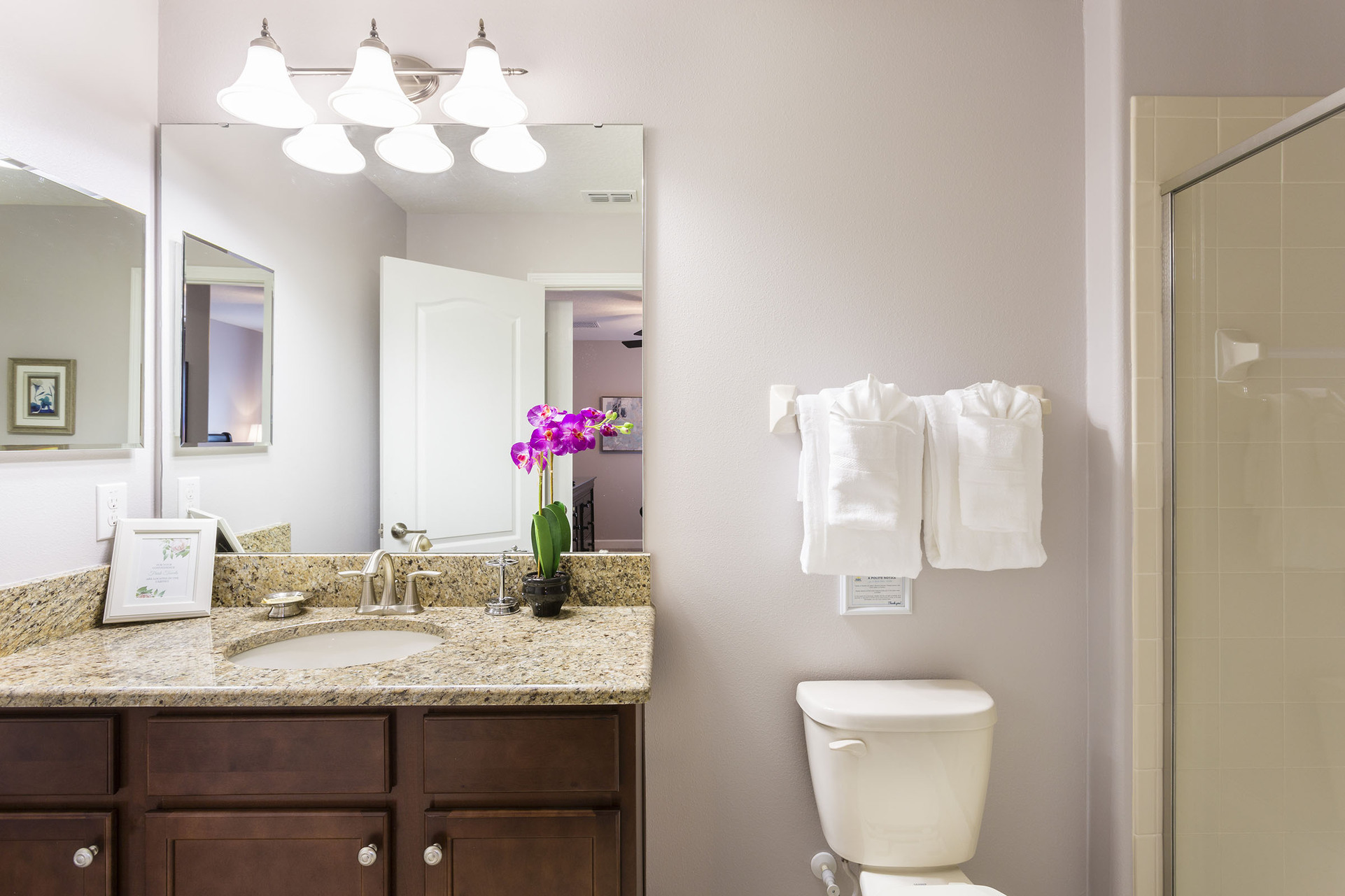 This ensuite bathroom has a glass walk-in shower