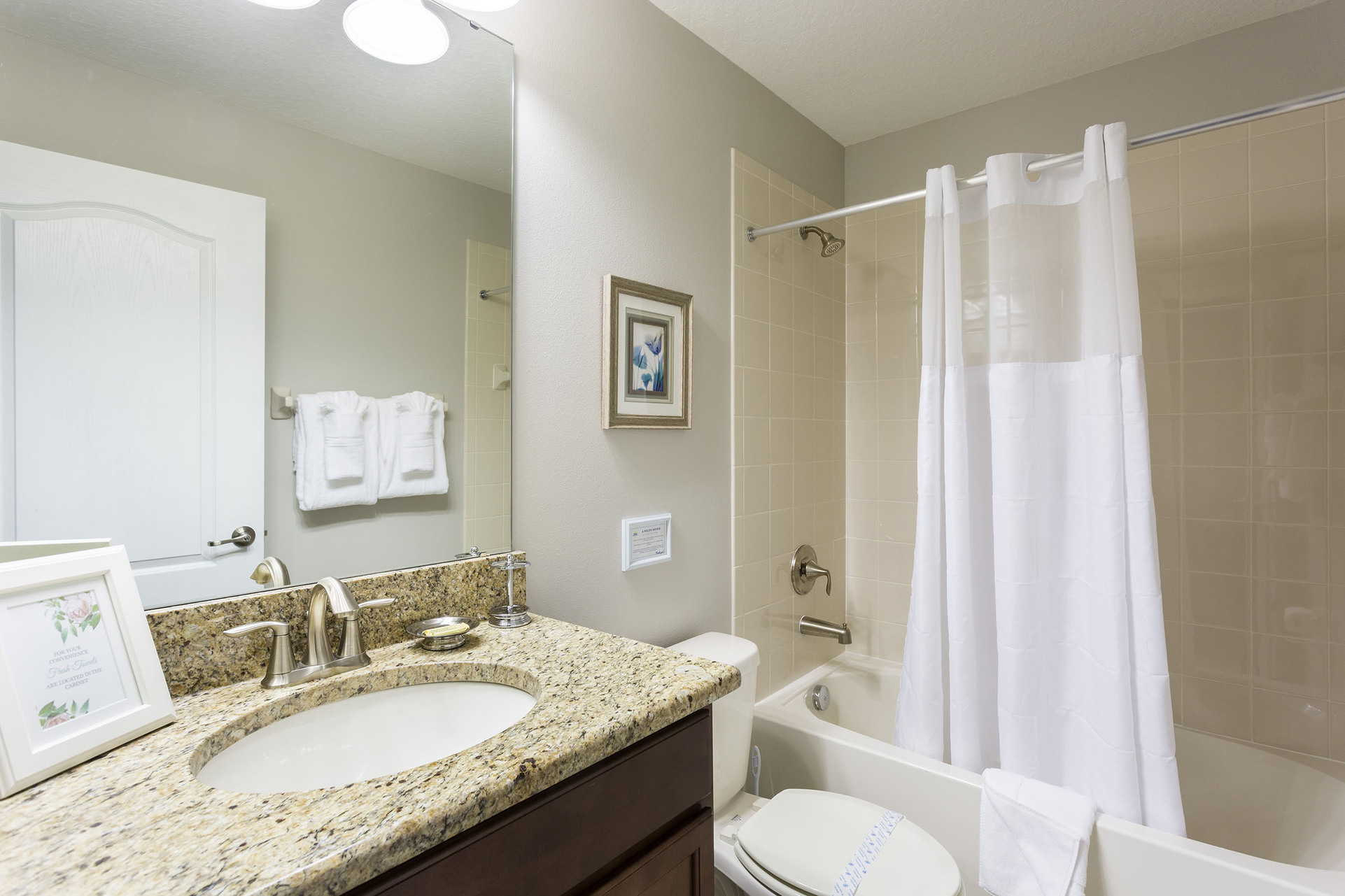 This bathroom features a combination shower and bathtub