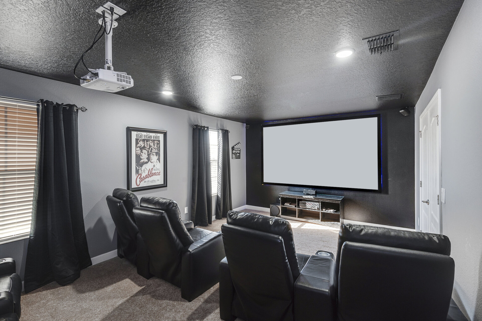 The theater seats 8 and has a 110-inch screen