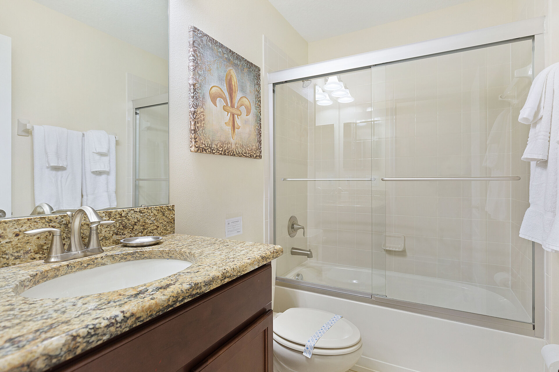 The ensuite bathroom features a dual vanity and shower/tub combination