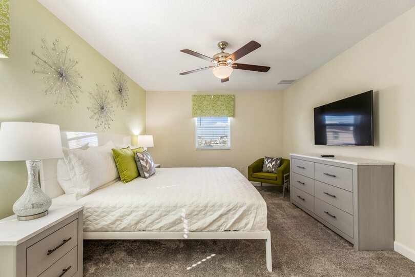 Green colored room with a king-size bedroom