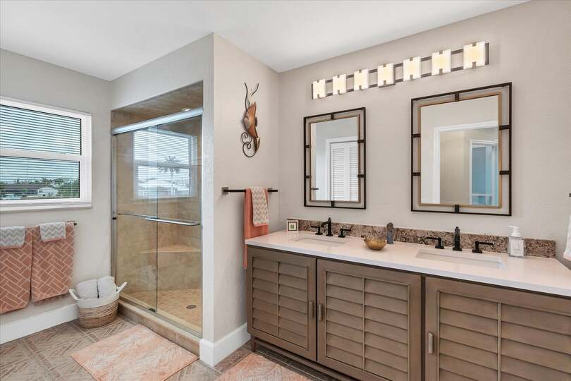 Downstairs guest bathroom with walk-in shower and double vanities