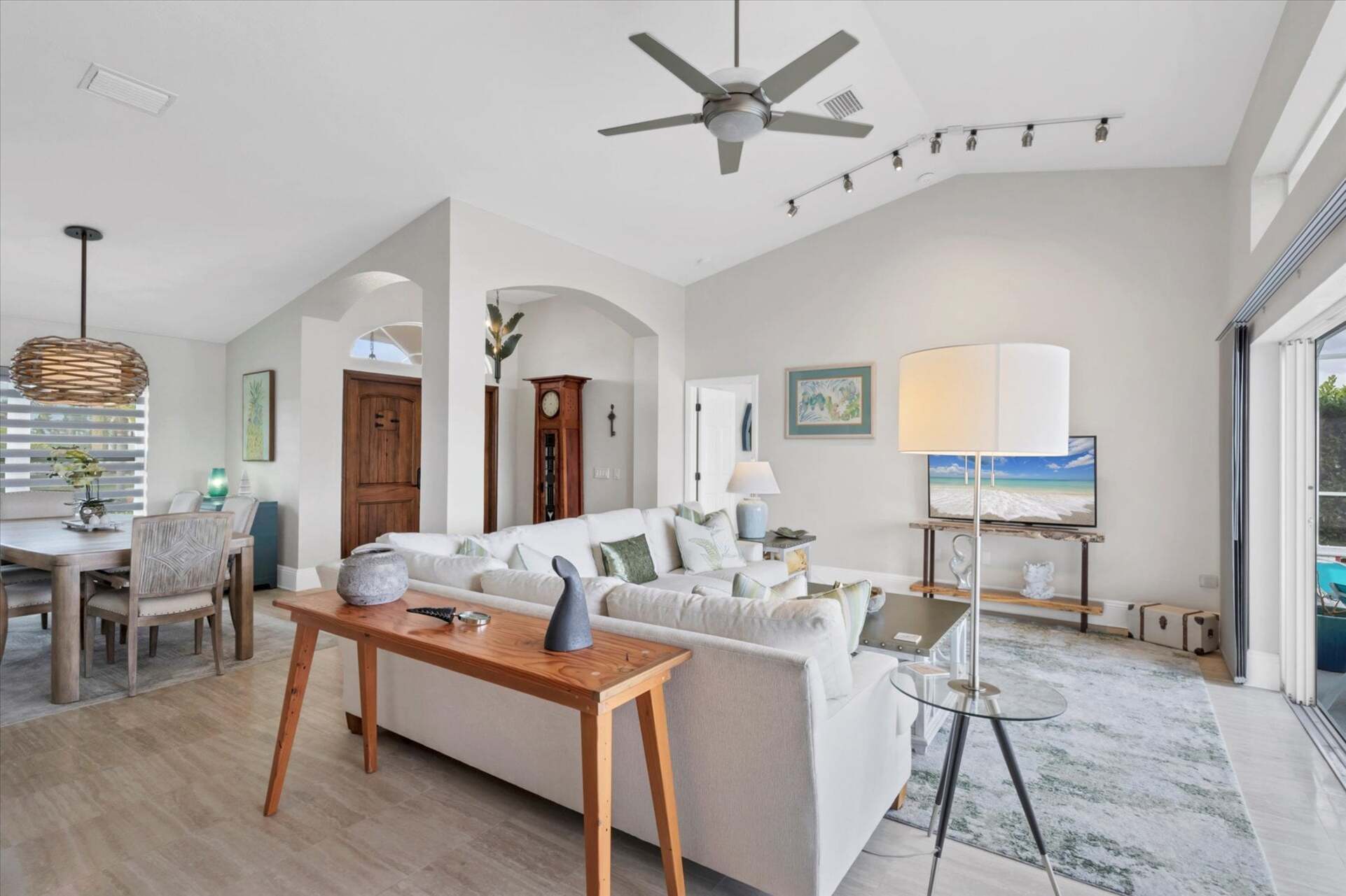 Family room overlooking sparkling pool and canal beyond. Features comfy seating and a 56-inch Smart TV