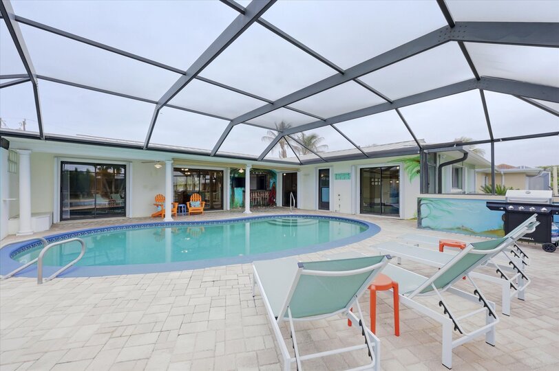 Large lanai with private sparkling pool is perfect for entertaining. Features sun loungers, dining table that seats 6, and 43-inch Smart TV