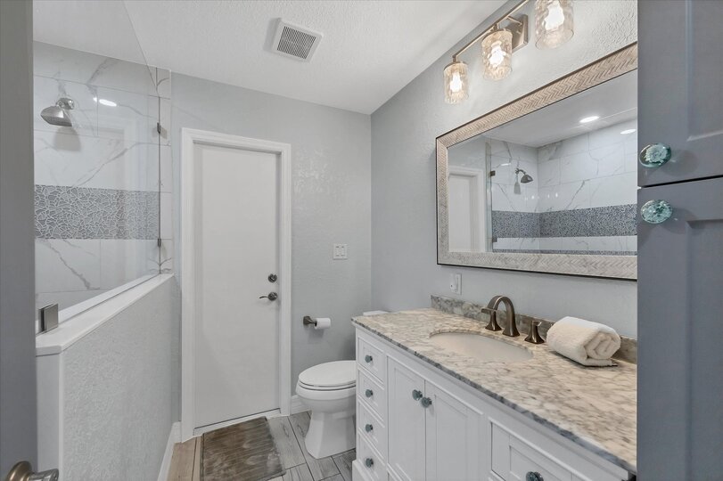 Guest bathroom featuring large walk-in shower