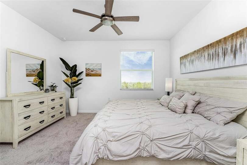 Primary bedroom with king bed and attached bathroom