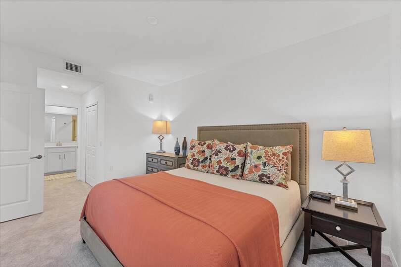 Primary bedroom with king bed and attached bathroom