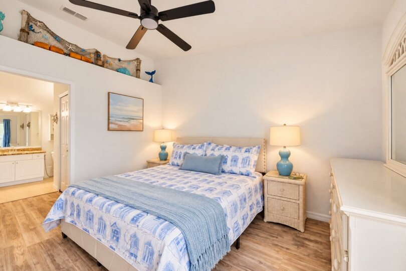 Primary bedroom with king bed, attached bathroom and 37-inch TV