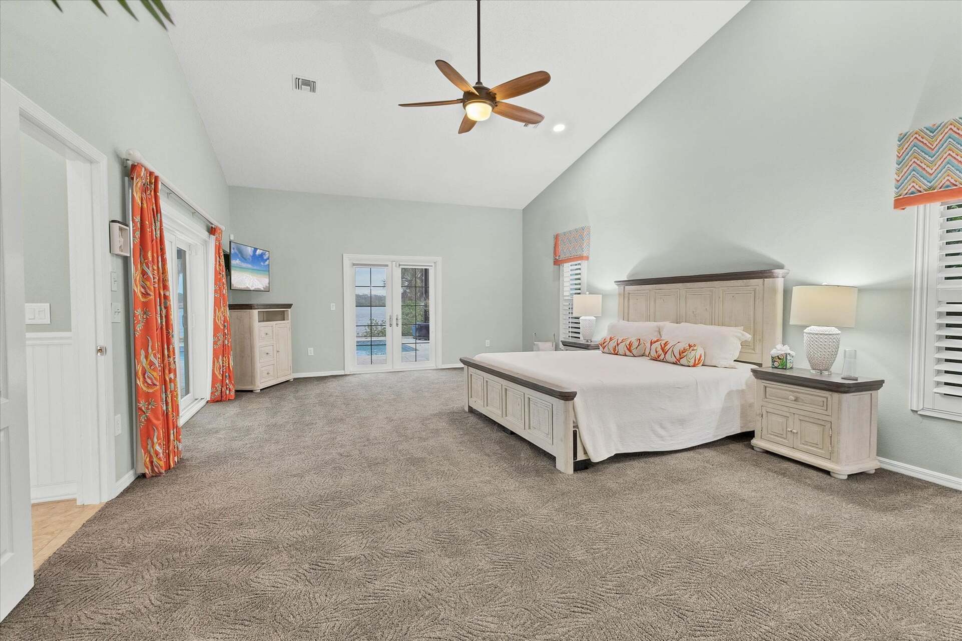 Primary bedroom features a king bed, lanai access, beautiful en suite, and 48-inch Smart TV