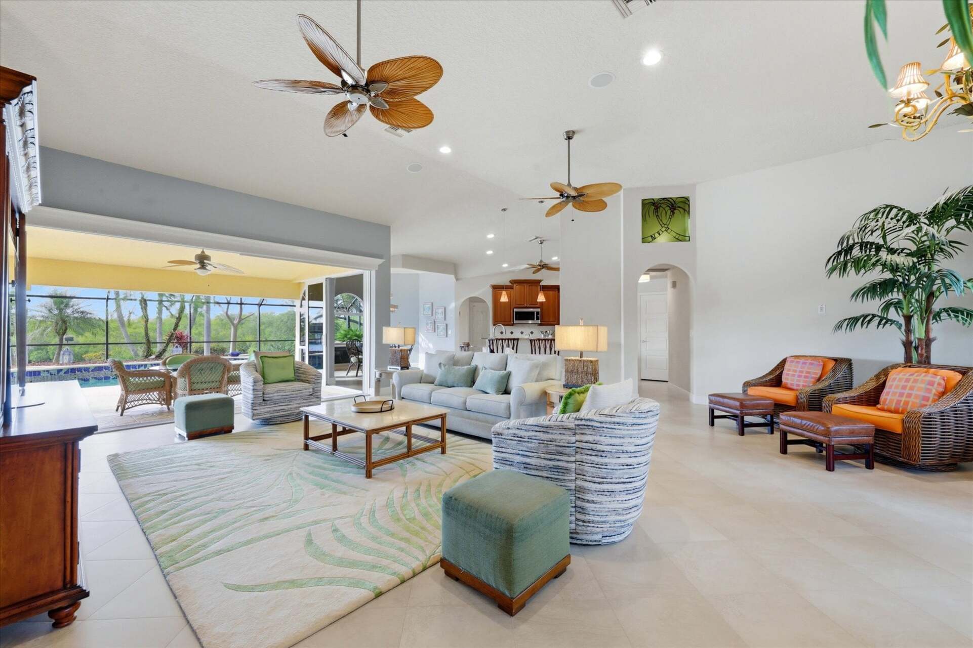 Large open living space overlooking the pool & canal beyond. Living room features lots of seating and 65-inch Smart TV