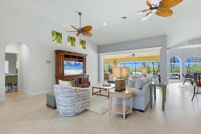 Large open living space overlooking the pool & canal beyond. Living room features lots of seating and 65-inch Smart TV