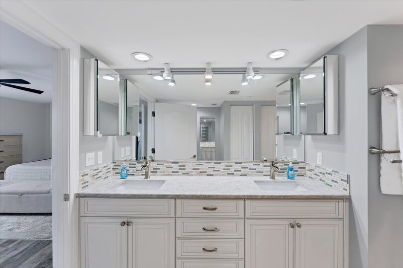 Primary Bathroom With Double Vanities and Walk-In Shower