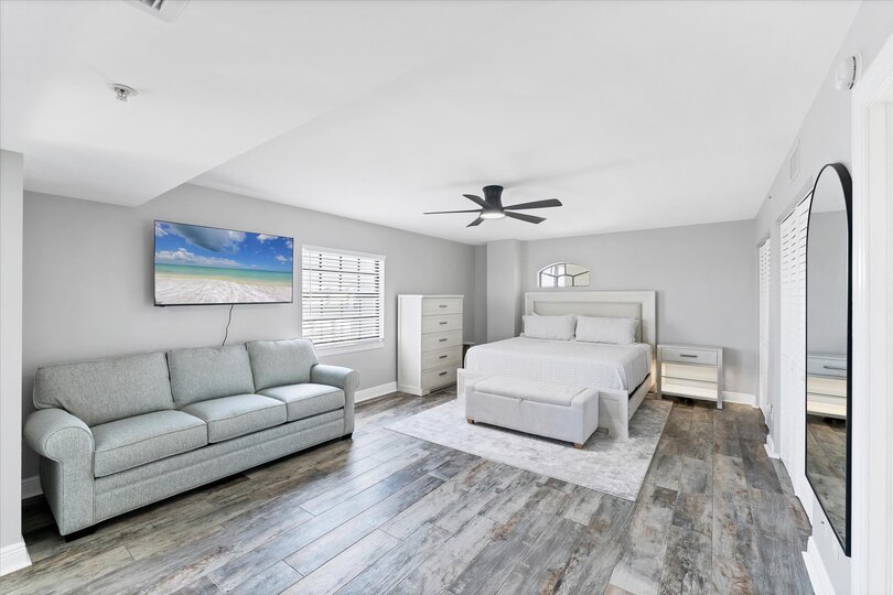 Primary Bedroom With King Bed,  attached bathroom, 50-inch Smart TV, and balcony access