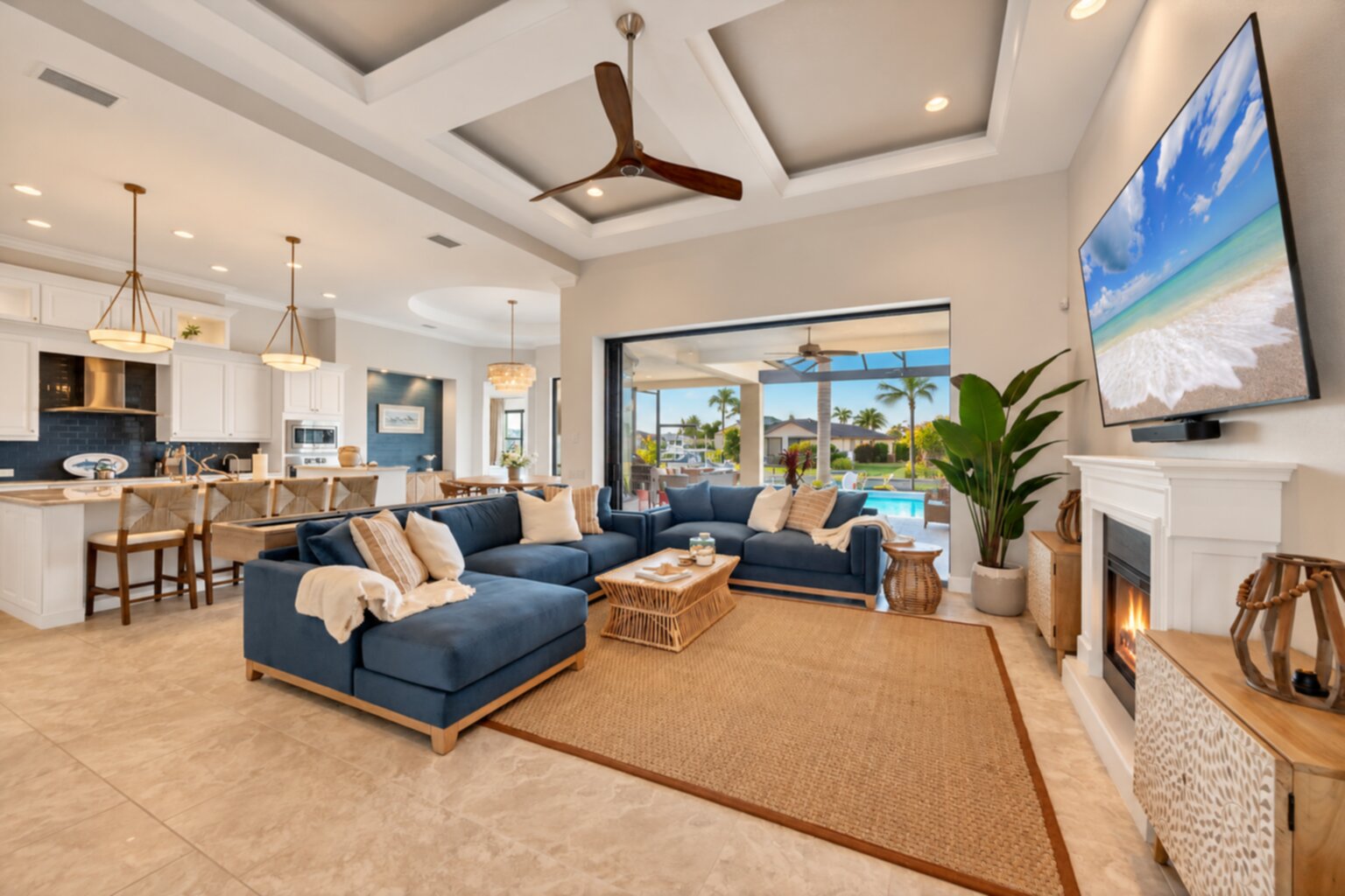 Beautiful, bright, open living space. Living room features ample seating, shuffleboard table, electric fireplace, lanai access, and huge 84-inch Smart TV