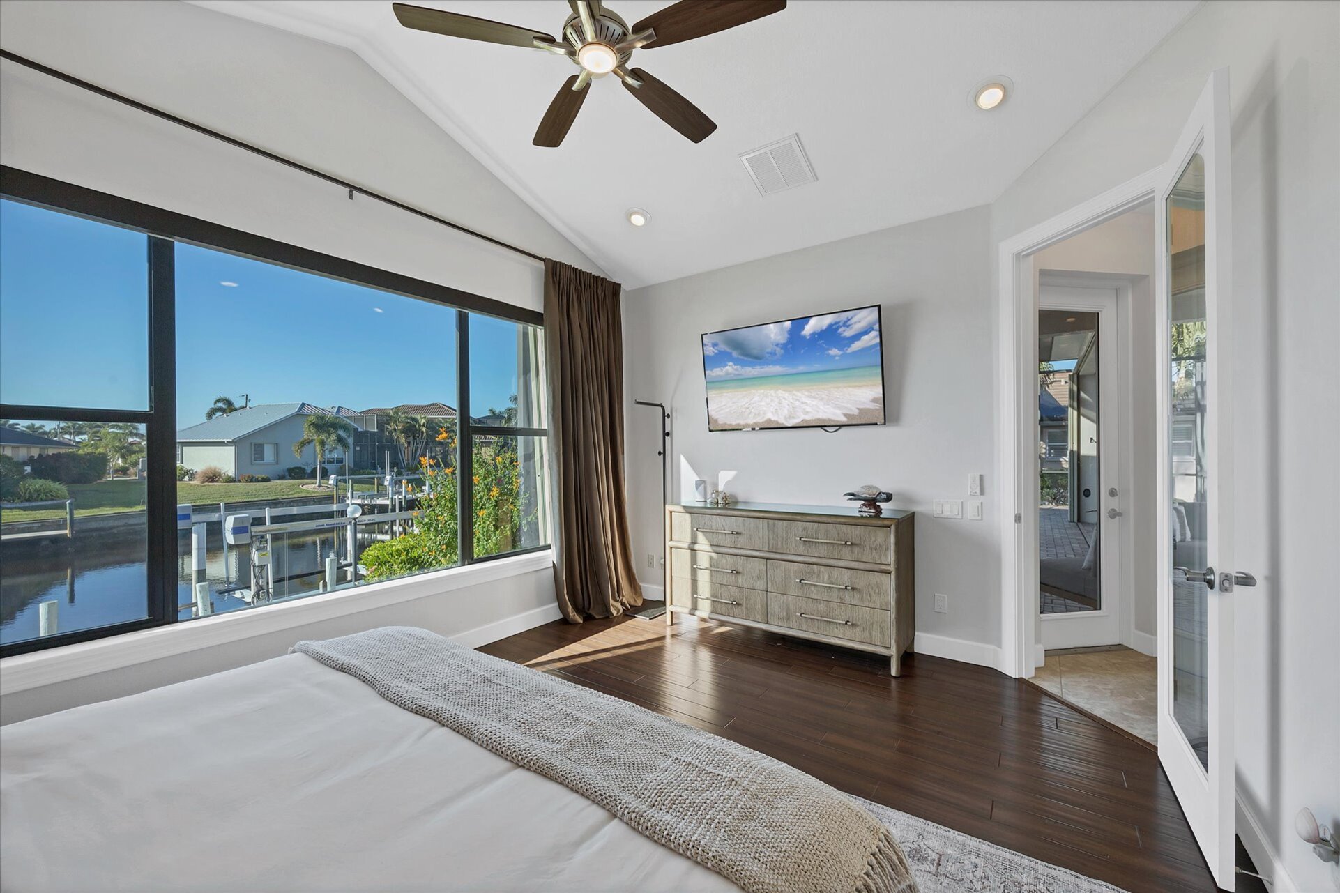 Guest bedroom 1 with king bed 65-inch Smart TV, and fabulous water view